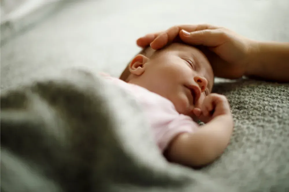 how to train newborn to sleep in bassinet